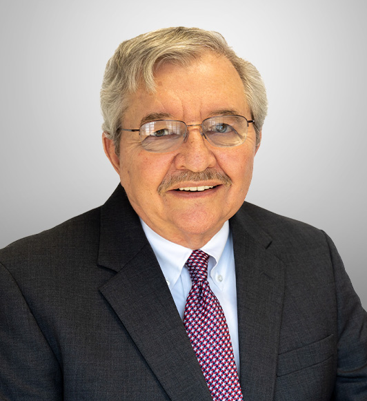 Attorney Marvin Beshore in a black suit jacket and red and blue tie