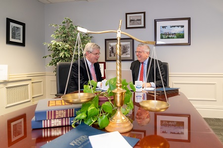 2 lawyers sitting at a table and talking to each other