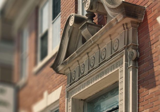 A brick building with a stone arch above the door